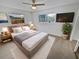 Main bedroom with plush carpet, ample natural light, and a ceiling fan at 11397 86Th Ave, Seminole, FL 33772