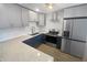 Modern kitchen with gray shaker cabinets, quartz countertops, and stainless steel appliances at 11397 86Th Ave, Seminole, FL 33772