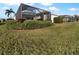 Spacious backyard with a screened patio and lush landscaping at 7431 39Th E Ct, Sarasota, FL 34243