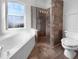 Bathroom with soaking tub, walk-in shower, and tile flooring at 7431 39Th E Ct, Sarasota, FL 34243