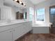 Bathroom features double vanity, soaking tub, and walk-in shower at 7431 39Th E Ct, Sarasota, FL 34243