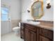 Updated bathroom with granite vanity, large mirror, and private access at 7431 39Th E Ct, Sarasota, FL 34243
