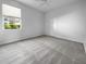Simple bedroom with neutral decor and carpeting at 7431 39Th E Ct, Sarasota, FL 34243