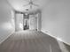 Bright bedroom with carpet flooring and access to hallway at 7431 39Th E Ct, Sarasota, FL 34243