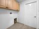 Laundry room with built-in cabinets and hookups for washer and dryer at 7431 39Th E Ct, Sarasota, FL 34243