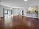 Spacious living room with hardwood floors and views to the kitchen and pool at 7431 39Th E Ct, Sarasota, FL 34243