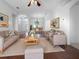 Bright living room with hardwood floors, comfortable seating, and large windows at 7431 39Th E Ct, Sarasota, FL 34243
