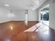 Sunlit living room with hardwood floors and pool access at 7431 39Th E Ct, Sarasota, FL 34243
