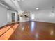 Open concept living room with kitchen view and hardwood floors at 7431 39Th E Ct, Sarasota, FL 34243