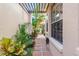 Pathway with pergola and lush tropical foliage at 818 Via Tripoli, Punta Gorda, FL 33950