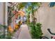 Landscaped walkway with tropical plants and orange umbrella at 818 Via Tripoli, Punta Gorda, FL 33950