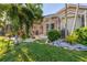 Landscaped backyard with tropical plants and grassy area at 818 Via Tripoli, Punta Gorda, FL 33950