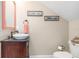 Updated bathroom features a vessel sink, dark vanity, and coral accents at 818 Via Tripoli, Punta Gorda, FL 33950