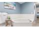 Relaxing bathroom with a large corner tub and updated fixtures at 818 Via Tripoli, Punta Gorda, FL 33950