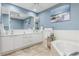 Elegant bathroom with double vanity, large mirror, and soaking tub at 818 Via Tripoli, Punta Gorda, FL 33950