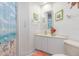 Bathroom with double vanity and beach-themed decor at 818 Via Tripoli, Punta Gorda, FL 33950
