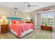 Bedroom with coral bedding, wood accents, and shutters at 818 Via Tripoli, Punta Gorda, FL 33950