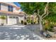 Two-story home with white garage door and landscaping at 818 Via Tripoli, Punta Gorda, FL 33950