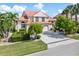 Two-story house with terracotta roof, double garage, and manicured lawn at 818 Via Tripoli, Punta Gorda, FL 33950