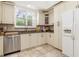 Modern kitchen with white cabinets, granite counters, and stainless steel appliances at 818 Via Tripoli, Punta Gorda, FL 33950