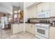 Bright kitchen boasts white cabinets, granite countertops, and a breakfast bar at 818 Via Tripoli, Punta Gorda, FL 33950