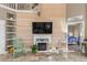 Spacious living room with fireplace, built-in shelving, and a wall-mounted TV at 818 Via Tripoli, Punta Gorda, FL 33950