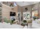 Open living space showcasing a fireplace, wood-paneled wall, and comfy seating at 818 Via Tripoli, Punta Gorda, FL 33950