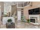 Bright living room featuring a fireplace, vaulted ceilings and white sofas at 818 Via Tripoli, Punta Gorda, FL 33950