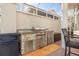 Outdoor kitchen with stainless steel appliances and stonework at 818 Via Tripoli, Punta Gorda, FL 33950