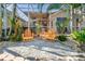 Relaxing patio with orange chairs and tropical plants at 818 Via Tripoli, Punta Gorda, FL 33950