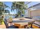 Covered patio overlooking canal with fire pit and grill at 818 Via Tripoli, Punta Gorda, FL 33950