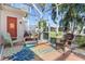 Cozy screened porch with wicker furniture and rug at 818 Via Tripoli, Punta Gorda, FL 33950