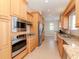 Well-equipped kitchen with stainless steel appliances and light wood cabinets at 320 Georgia Ave, Crystal Beach, FL 34681