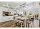 Bright dining area with a farmhouse style table and bench, adjacent to the kitchen at 4086 Gardner Dr, Port Charlotte, FL 33952