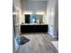 Double vanity bathroom with a large mirror and dark cabinets at 811 Manns Harbor Dr, Apollo Beach, FL 33572