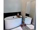 Relaxing bathroom with a free-standing tub and large mirror at 811 Manns Harbor Dr, Apollo Beach, FL 33572