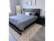 Modern bedroom with a gray bedding set and large mirror at 811 Manns Harbor Dr, Apollo Beach, FL 33572