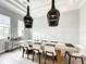 Modern dining room with concrete table and statement lighting at 811 Manns Harbor Dr, Apollo Beach, FL 33572