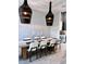 Modern dining room with concrete table and statement lighting at 811 Manns Harbor Dr, Apollo Beach, FL 33572