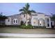 Two-story home with stone accents and palm trees at 811 Manns Harbor Dr, Apollo Beach, FL 33572