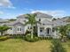 Two-story home with stone accents and palm trees at 811 Manns Harbor Dr, Apollo Beach, FL 33572