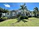 Two-story home with stone accents and palm trees at 811 Manns Harbor Dr, Apollo Beach, FL 33572