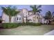 Two-story home with stone accents and palm trees at 811 Manns Harbor Dr, Apollo Beach, FL 33572