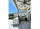 Outdoor kitchen with stainless steel appliances and granite countertop at 811 Manns Harbor Dr, Apollo Beach, FL 33572