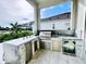 Outdoor kitchen with stainless steel appliances and stone accents at 811 Manns Harbor Dr, Apollo Beach, FL 33572
