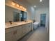 Elegant bathroom with double vanity, soaking tub, and separate toilet area at 135 Sunset Rd, Rotonda West, FL 33947