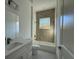 Clean, modern bathroom with vanity, tub-shower combo, and stylish tile accent wall at 135 Sunset Rd, Rotonda West, FL 33947
