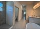 Bright bathroom has a walk-in shower and a stand alone tub with double sinks and tile flooring at 135 Sunset Rd, Rotonda West, FL 33947