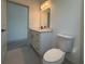 Clean bathroom with a toilet and vanity with quartz countertop at 135 Sunset Rd, Rotonda West, FL 33947