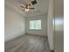 Bedroom featuring a ceiling fan, tray ceiling, and ample natural light from the window at 135 Sunset Rd, Rotonda West, FL 33947